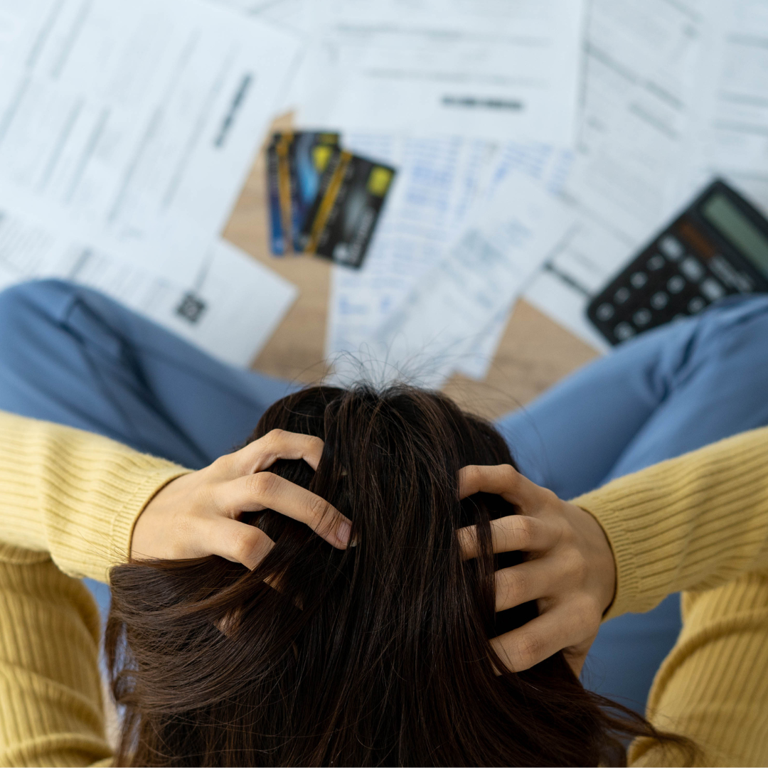 Illustration of a distressed consumer reviewing financial documents due to the car finance scandal